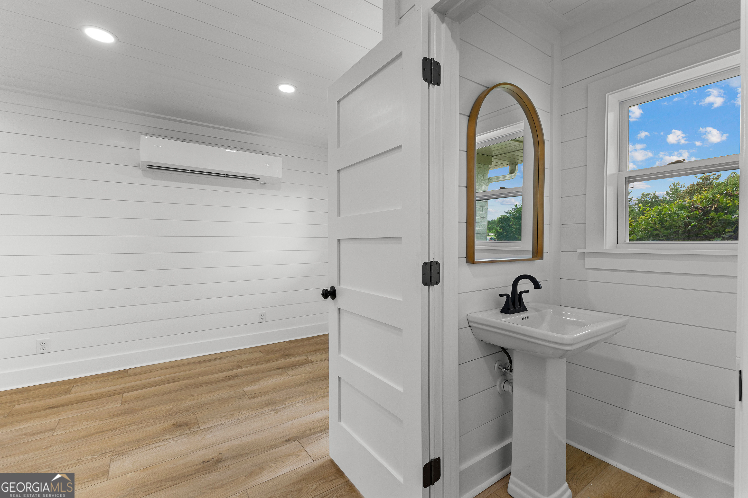 1367 Sharpsburg McCollum Road Sharpsburg, GA 30277 - Photo 26 of 80 a bathroom with a sink and a mirror