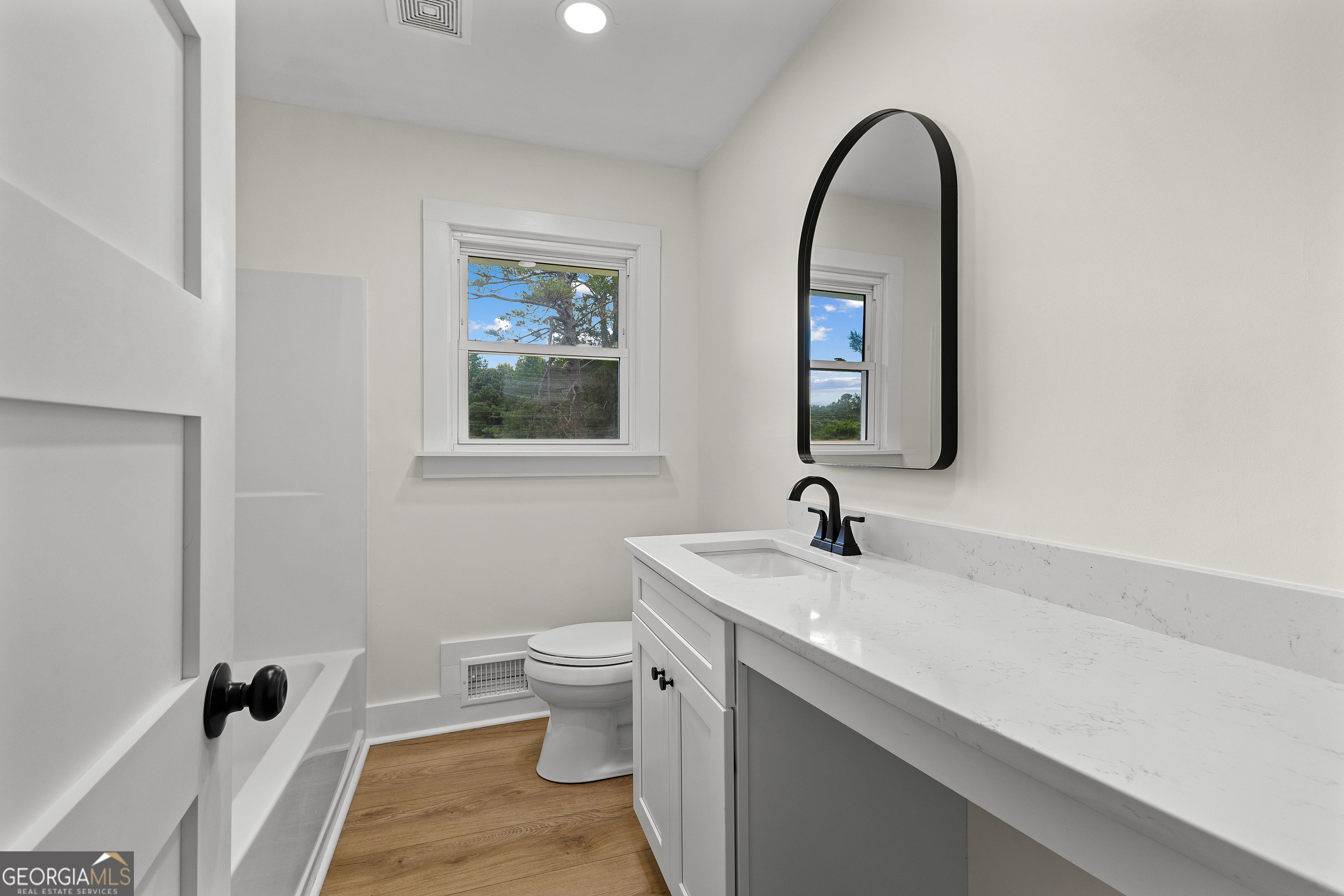 1367 Sharpsburg McCollum Road Sharpsburg, GA 30277 - Photo 35 of 80 a bathroom with a toilet sink and mirror