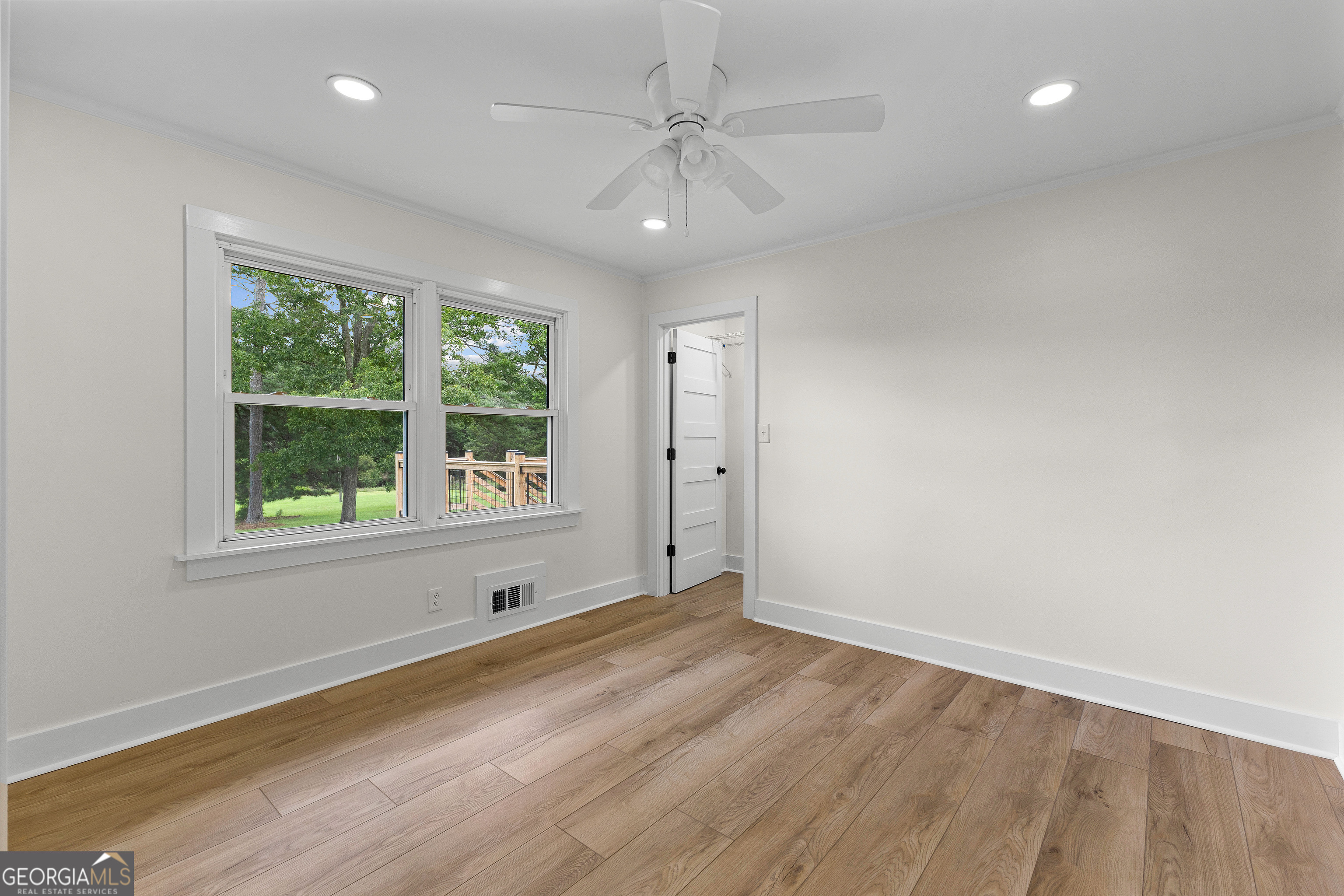 1367 Sharpsburg McCollum Road Sharpsburg, GA 30277 - Photo 38 of 80 an empty room with wooden floor and windows