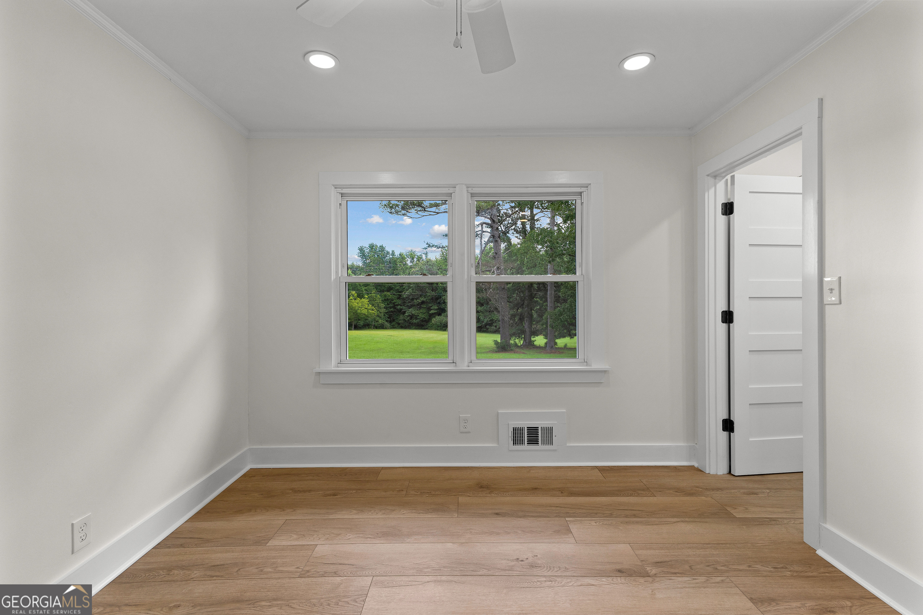 1367 Sharpsburg McCollum Road Sharpsburg, GA 30277 - Photo 39 of 80 an empty room with wooden floor and a window