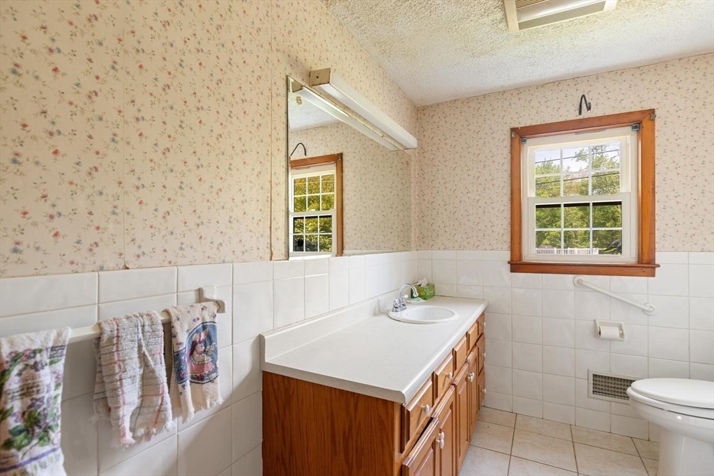 19 Butler Avenue Wakefield, MA 01880 - Photo 19 of 33 a bathroom with a sink a toilet and a window