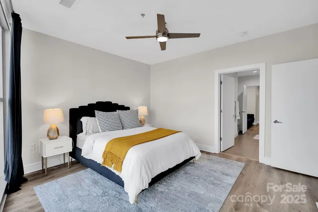 a bedroom with a bed and a chandelier