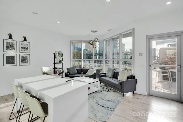 a living room with furniture and large windows