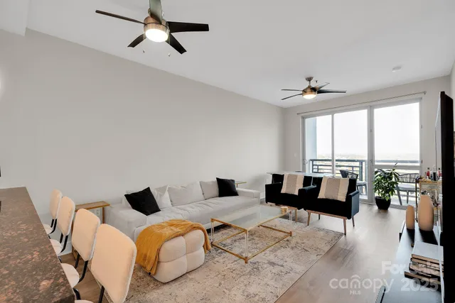 a living room with furniture and floor to ceiling windows
