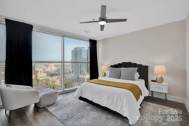 a bedroom with a bed and a large window