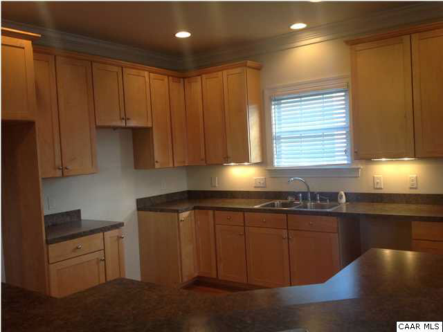 1350 Amber Ridge Road Charlottesville, VA 22901 - Photo 4 of 17 a kitchen with granite countertop wooden cabinets stainless steel appliances and a sink