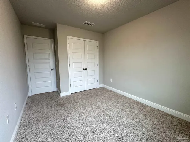 an empty room with closet area