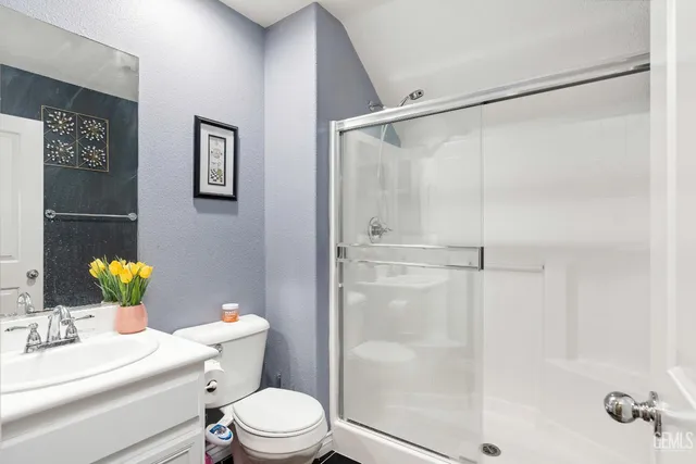a white toilet sitting next to a bathroom sink