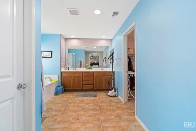 a bathroom with a sink a vanity and mirror
