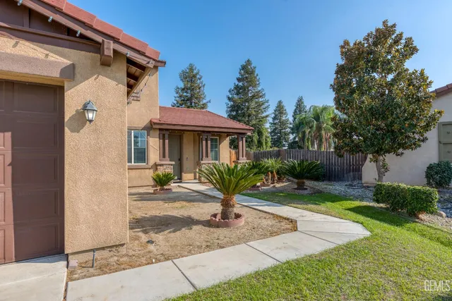 a front view of a house with garden and porch