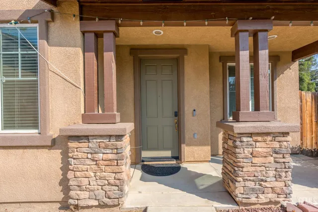 a front view of a house with large windows