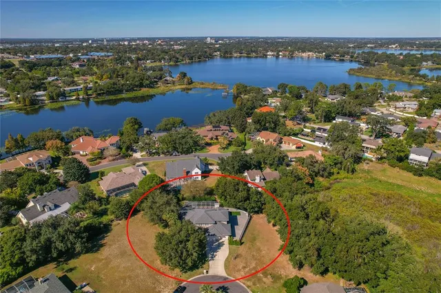 an aerial view of a house with a yard basket ball court and outdoor seating
