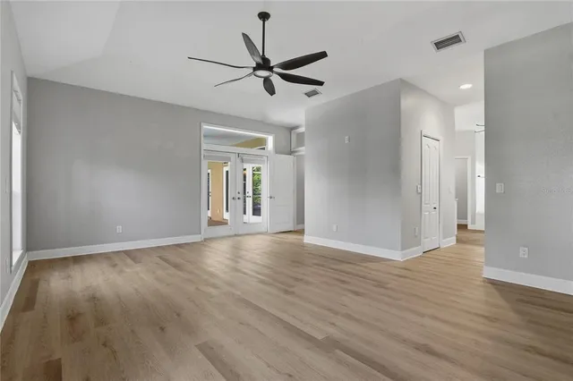 an empty room with windows and entrance