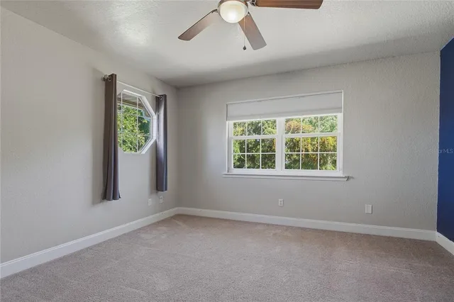 an aerial view of a house with garden space and street view