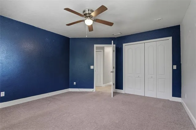 an aerial view of residential house with outdoor space and trees all around