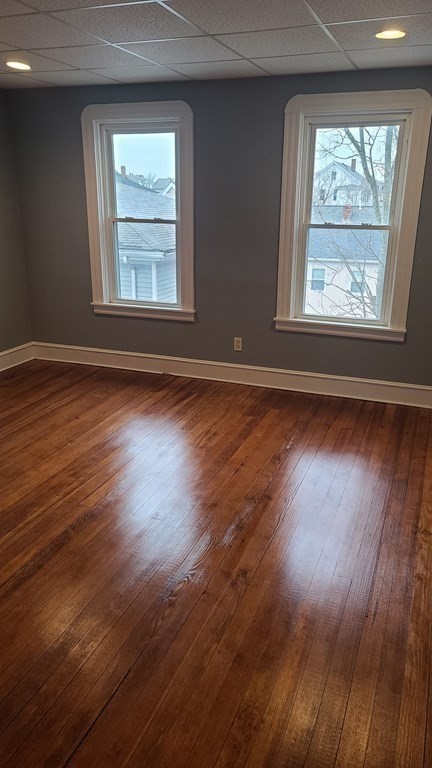 672 2nd Street Fall River, MA 02721 - Photo 11 of 16 an empty room with wooden floor and windows