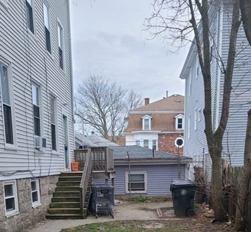 672 2nd Street Fall River, MA 02721 - Photo 2 of 16 a front view of a house with a garden