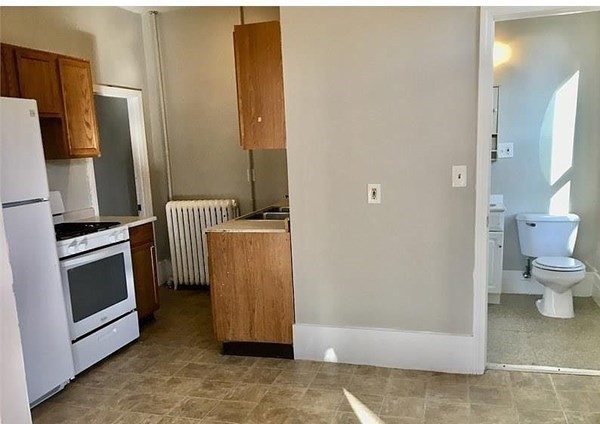 672 2nd Street Fall River, MA 02721 - Photo 8 of 16 a view of a kitchen from the hallway