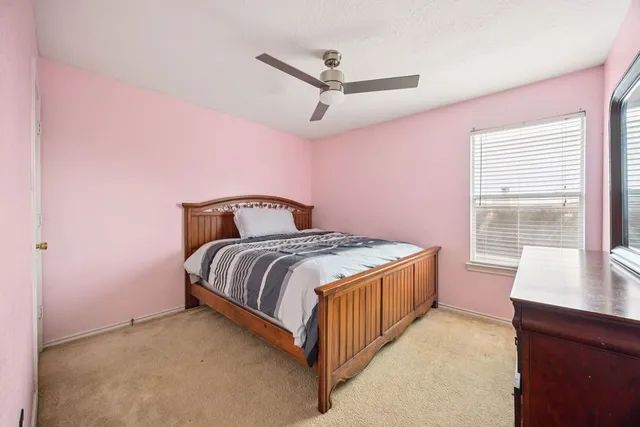 a bedroom with a bed and a desk