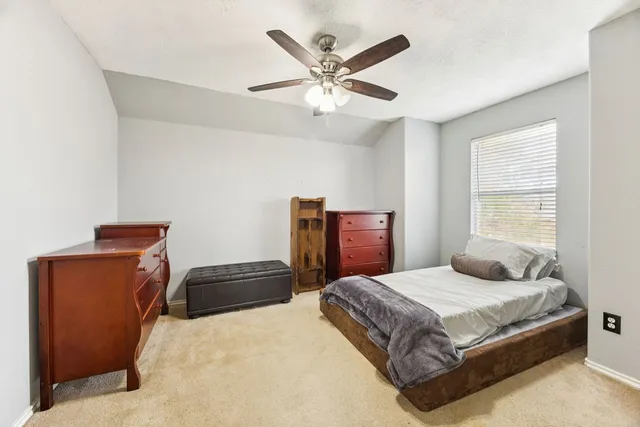 a bedroom with a bed and window