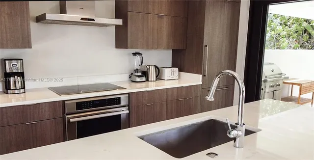 a kitchen with a sink and a stove