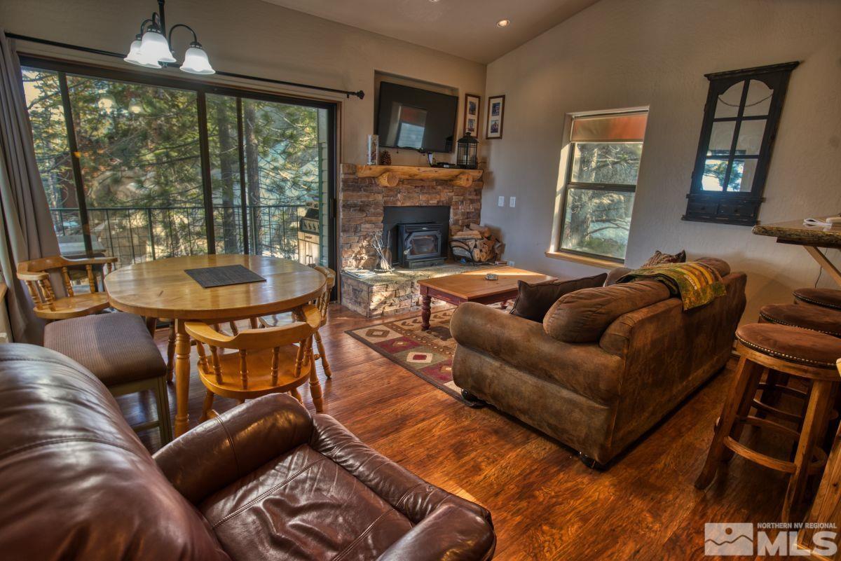 a living room with furniture a large window and a fireplace
