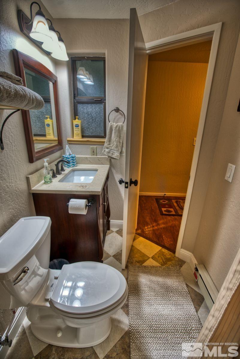313 Tramway Drive, Unit 26 Stateline, NV 89449 - Photo 11 of 19 a bathroom with a sink toilet and mirror