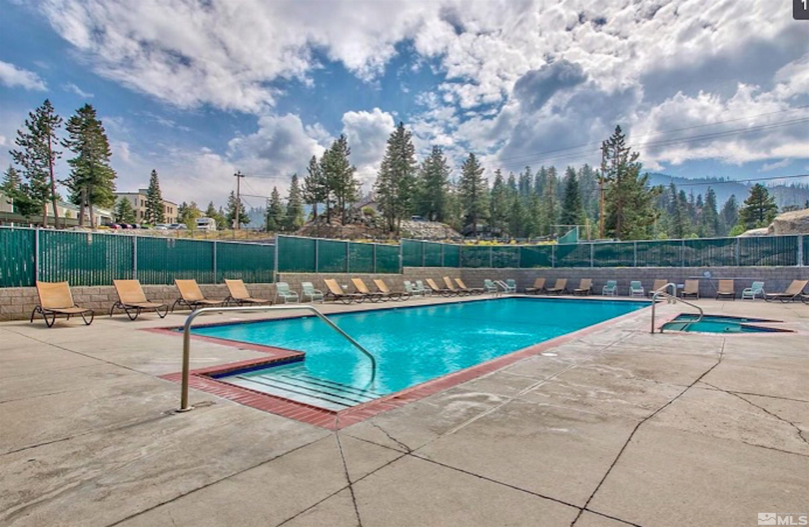 313 Tramway Drive, Unit 26 Stateline, NV 89449 - Photo 17 of 19 a view of swimming pool with seating space and trees