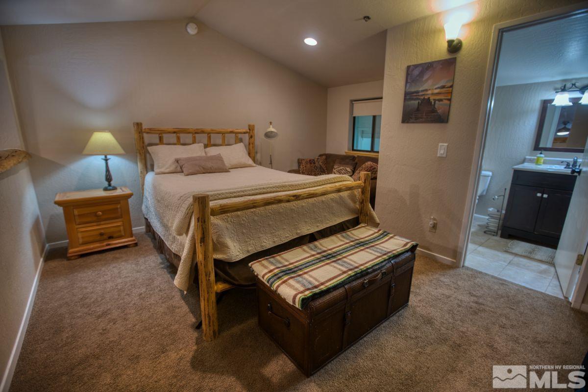 313 Tramway Drive, Unit 26 Stateline, NV 89449 - Photo 8 of 19 a bedroom with a bed and a view of living room