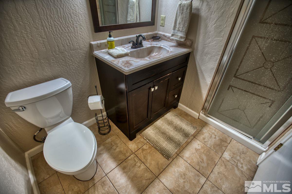 313 Tramway Drive, Unit 26 Stateline, NV 89449 - Photo 10 of 19 a bathroom with a toilet sink and mirror