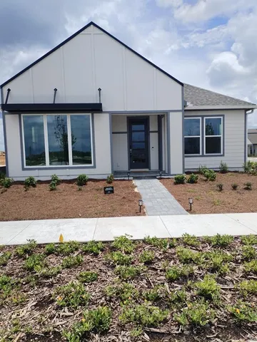a front view of a house with a sitting area