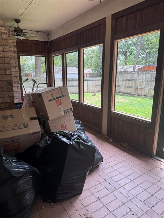 1704 South Bowen Road Pantego, TX 76013 - Photo 20 of 37 Sunroom featuring extensive window-lined walls, a brick accent column, and terracotta tile flooring
