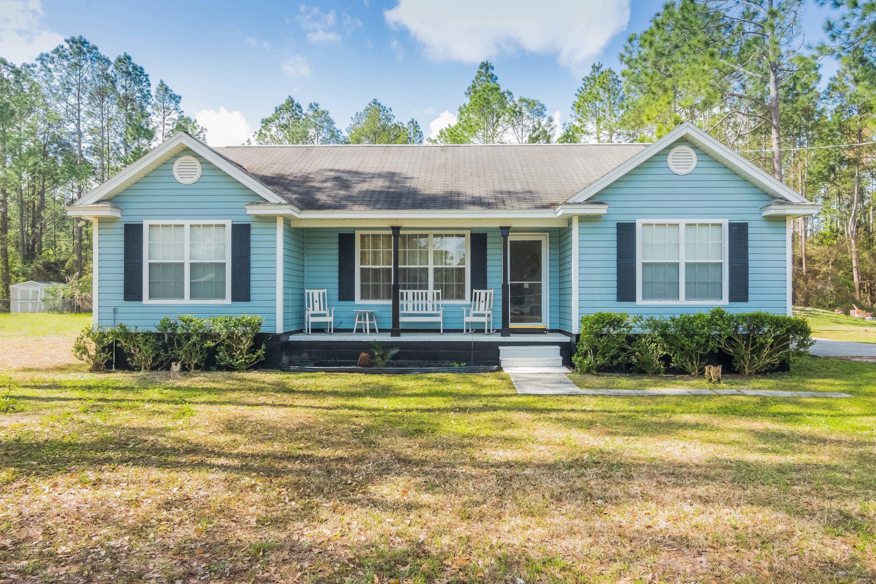 6345 Armstrong Road Elkton, FL 32033 - Photo 1 of 26 a view of a house with swimming pool and a yard