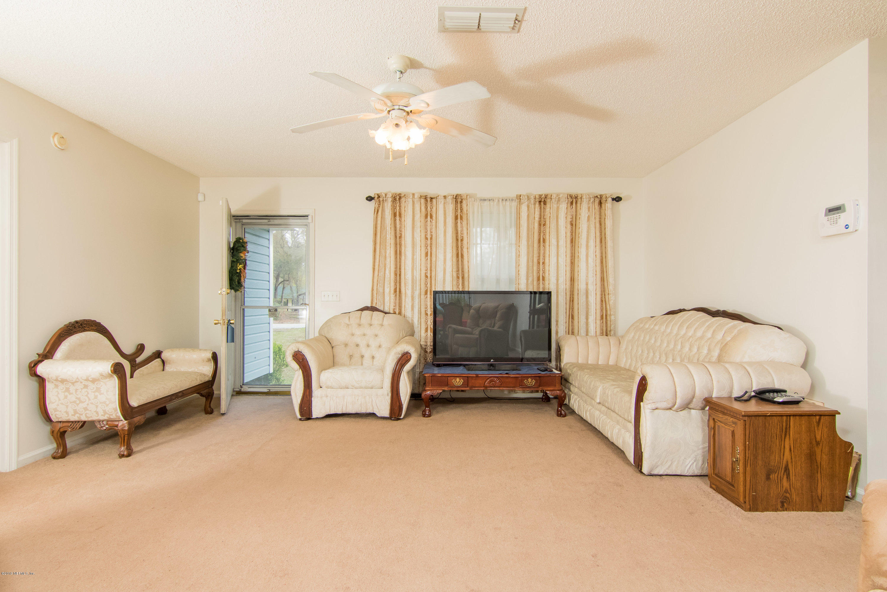 6345 Armstrong Road Elkton, FL 32033 - Photo 11 of 26 a living room with furniture and a flat screen tv