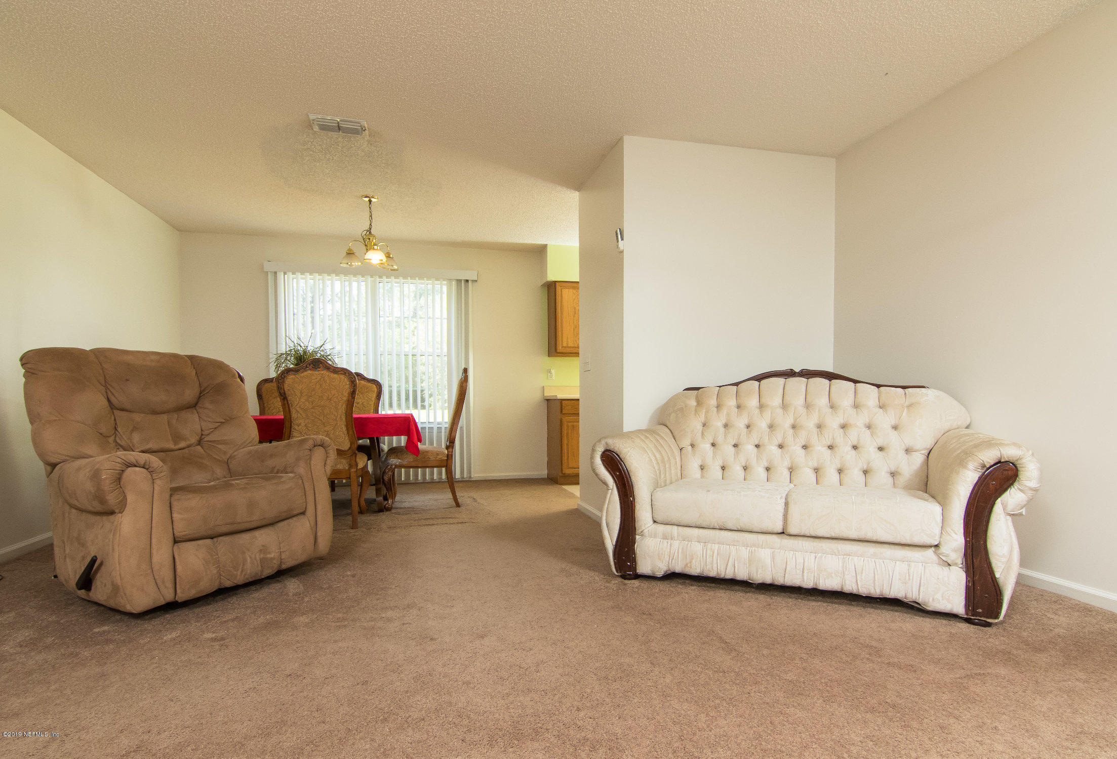 6345 Armstrong Road Elkton, FL 32033 - Photo 14 of 26 a living room with furniture and a couch
