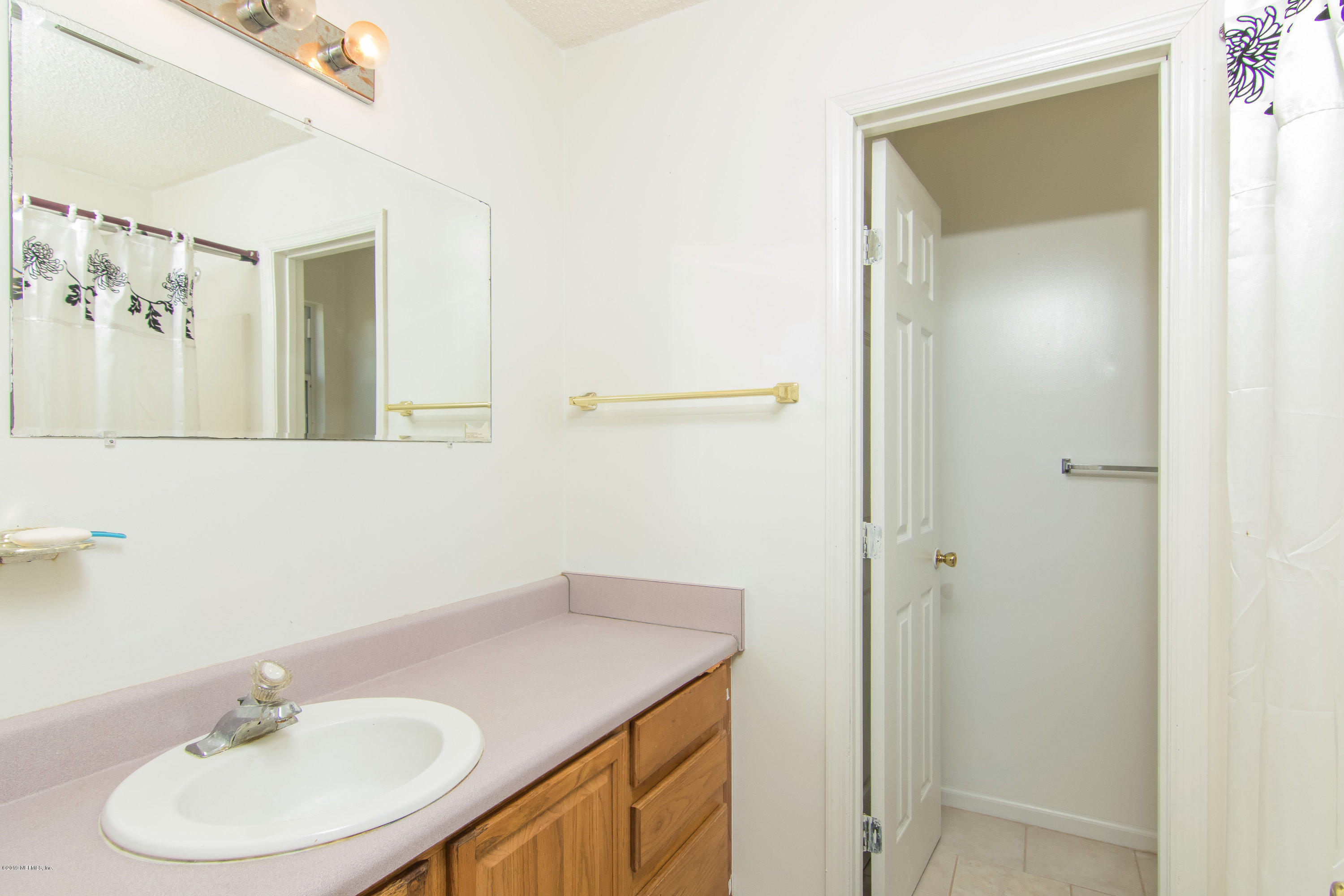 6345 Armstrong Road Elkton, FL 32033 - Photo 16 of 26 a bathroom with a sink and a mirror
