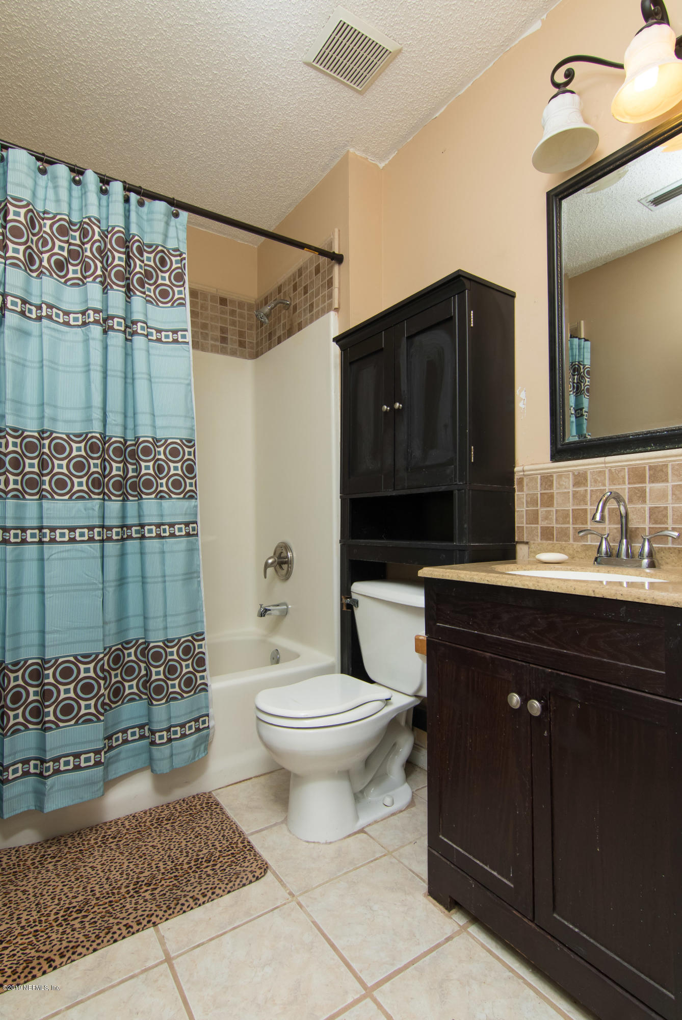 6345 Armstrong Road Elkton, FL 32033 - Photo 19 of 26 a bathroom with a sink toilet and shower