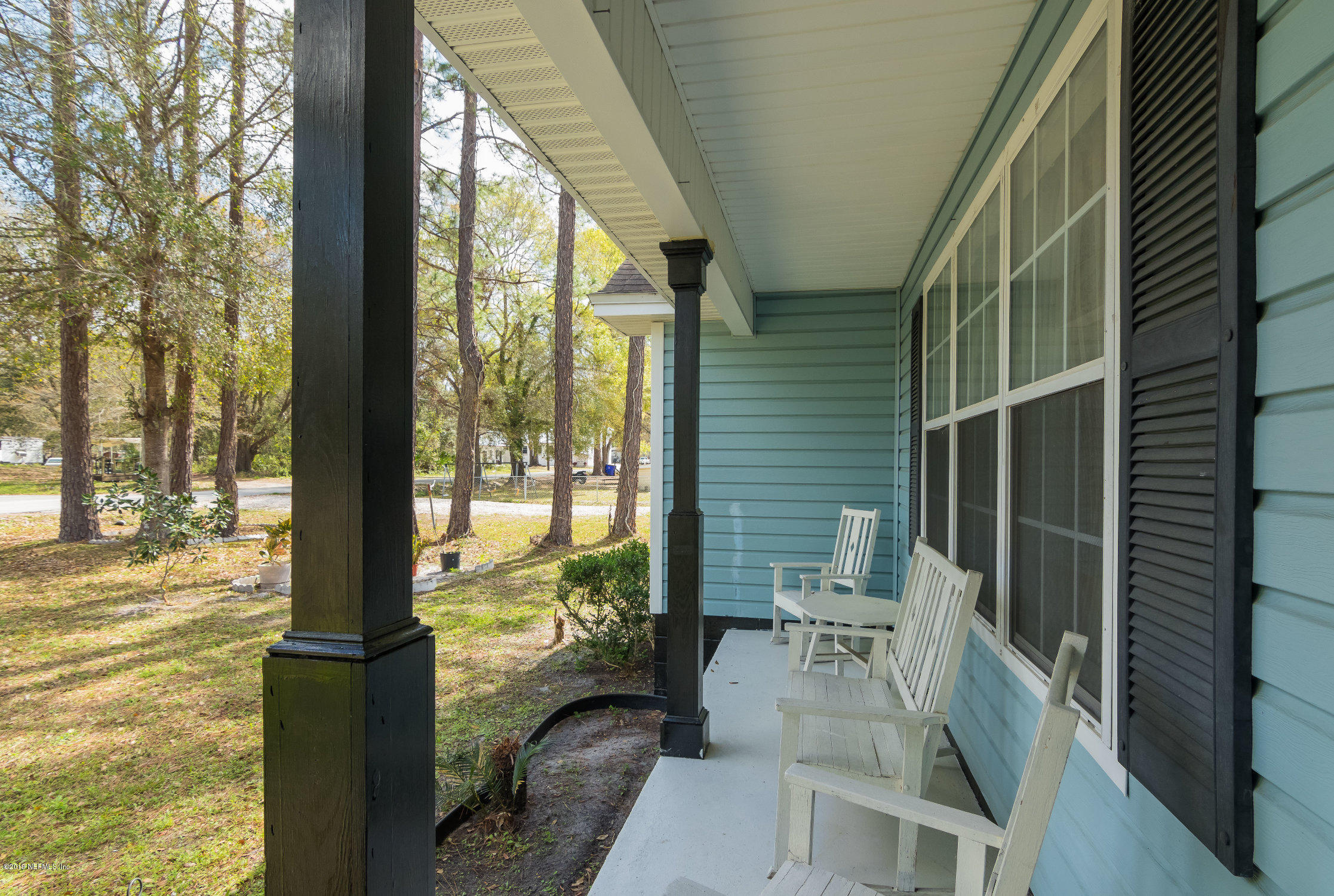 6345 Armstrong Road Elkton, FL 32033 - Photo 20 of 26 a view of balcony with floor to ceiling window and wooden floor