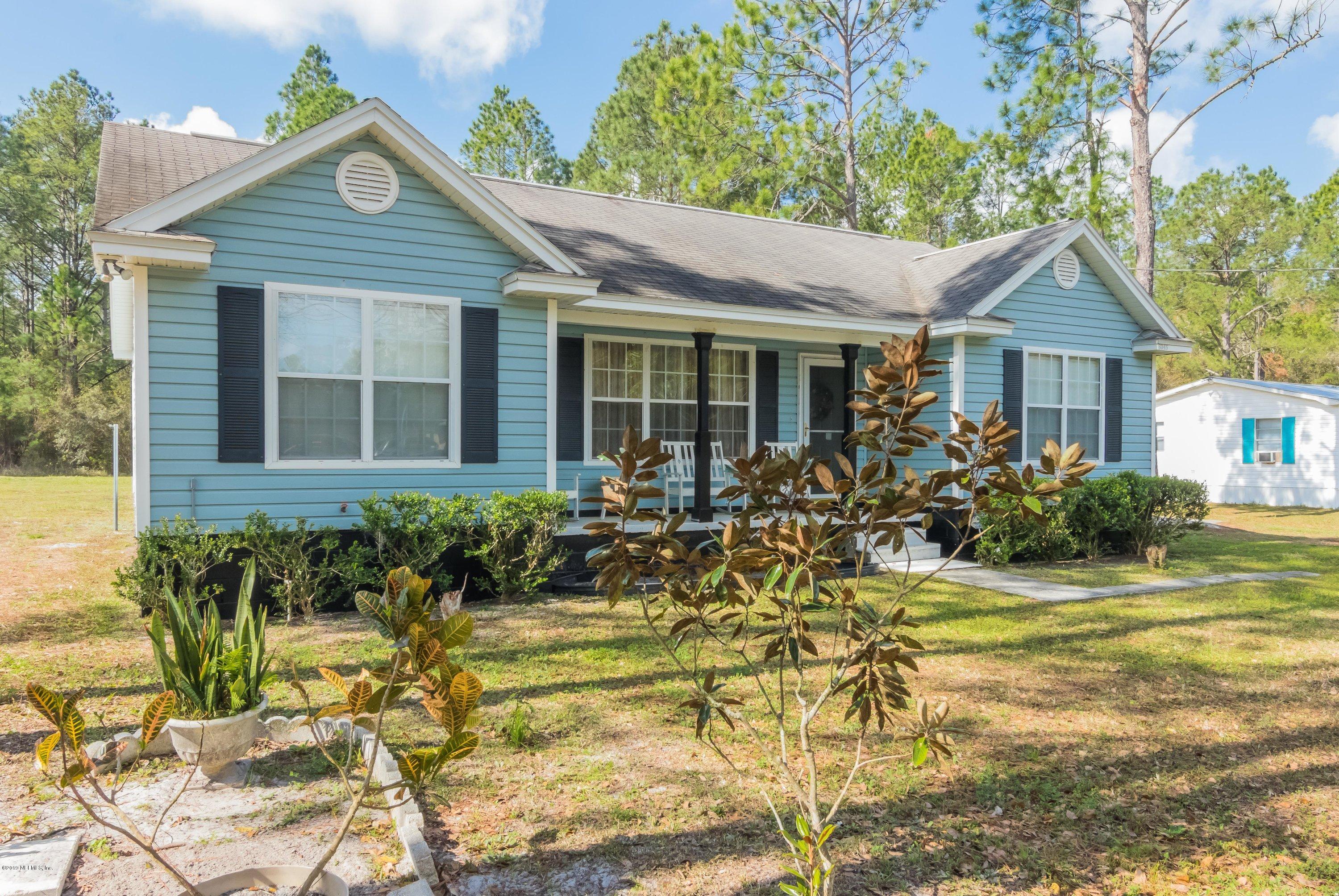 6345 Armstrong Road Elkton, FL 32033 - Photo 2 of 26 a front view of a house with a yard