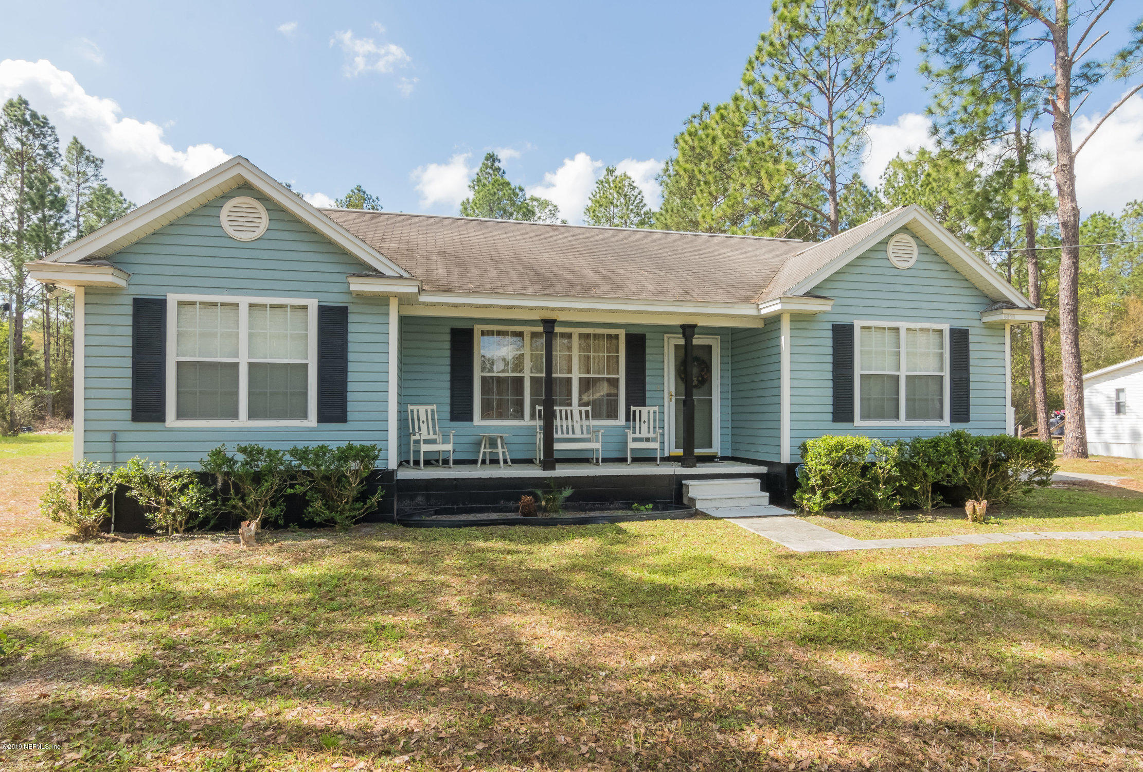 6345 Armstrong Road Elkton, FL 32033 - Photo 21 of 26 a front view of a house with a yard