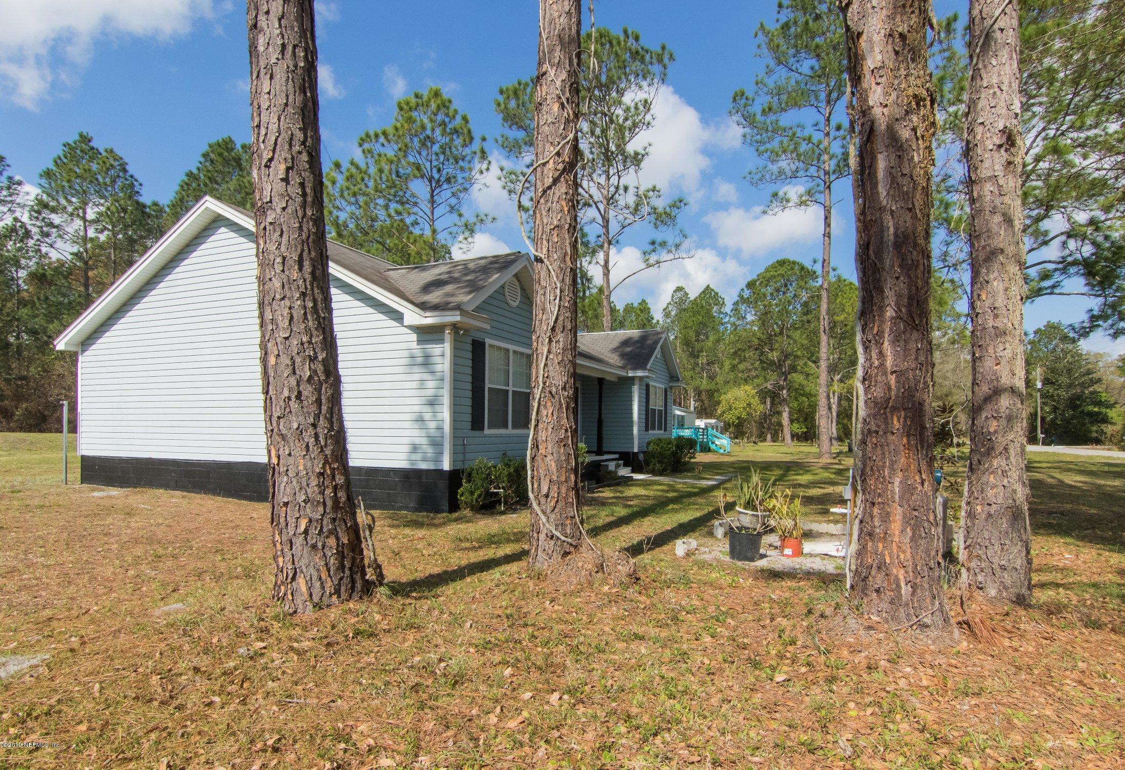 6345 Armstrong Road Elkton, FL 32033 - Photo 3 of 26 a view of a house with backyard and trees