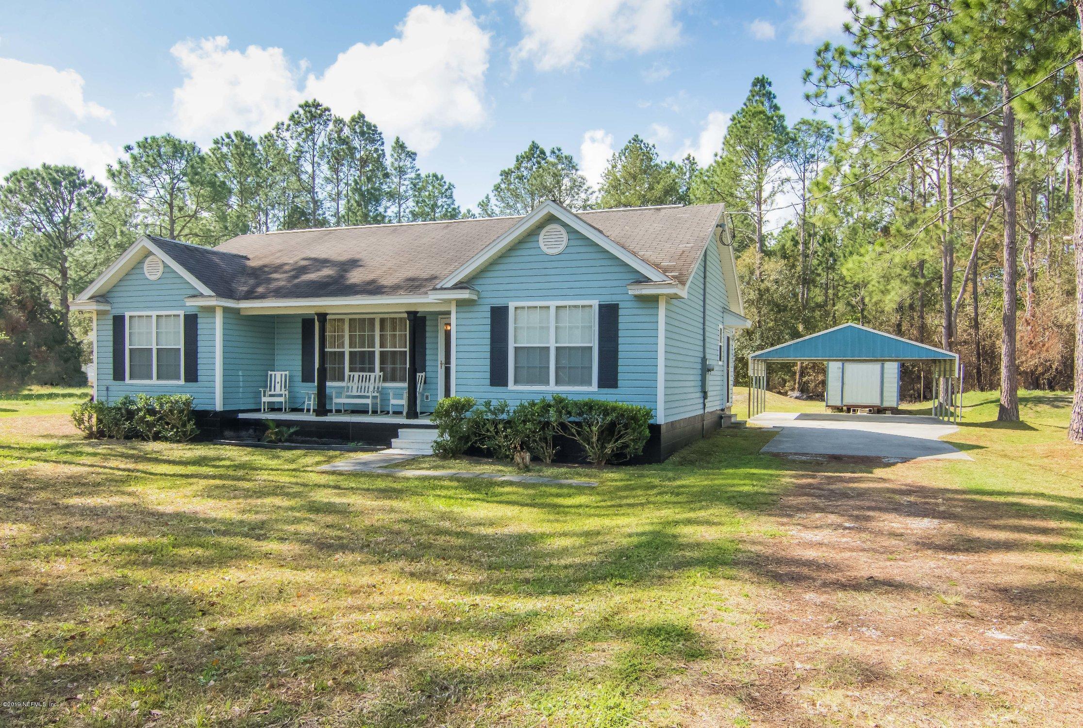 6345 Armstrong Road Elkton, FL 32033 - Photo 7 of 26 a front view of a house with a garden