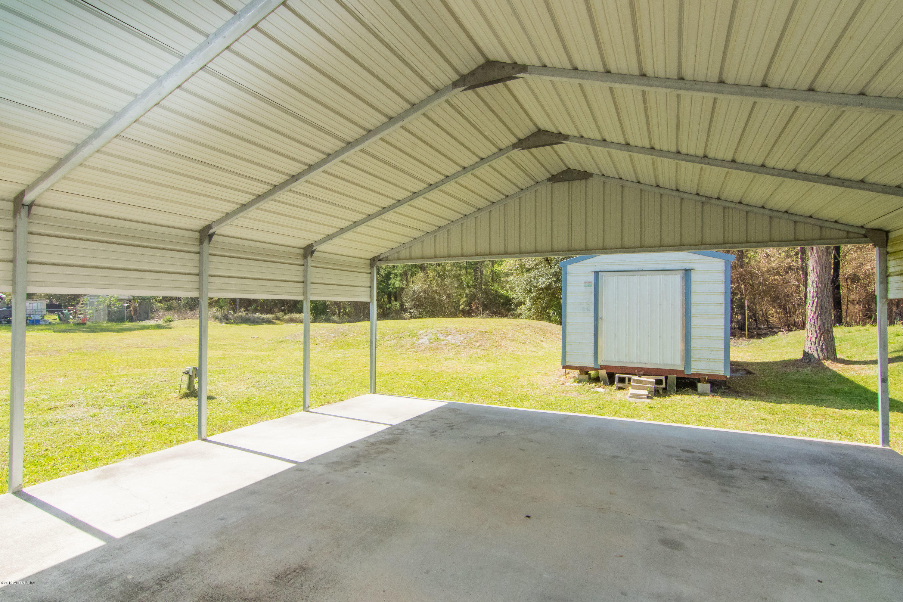 6345 Armstrong Road Elkton, FL 32033 - Photo 8 of 26 a view of swimming pool with table and chairs under an umbrella