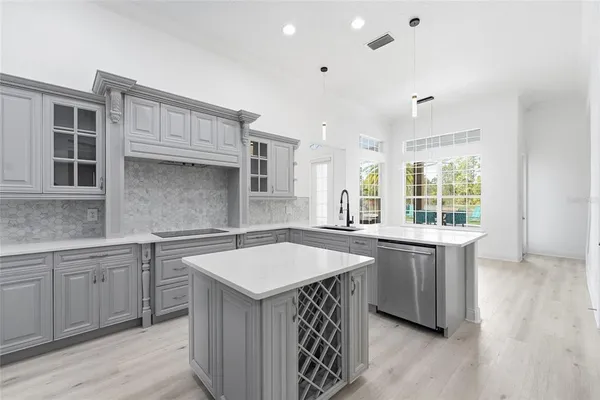 a kitchen with a sink stove and cabinets