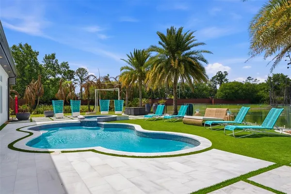 a view of a swimming pool with chairs