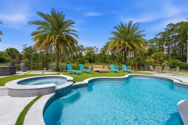 a swimming pool with outdoor seating and yard