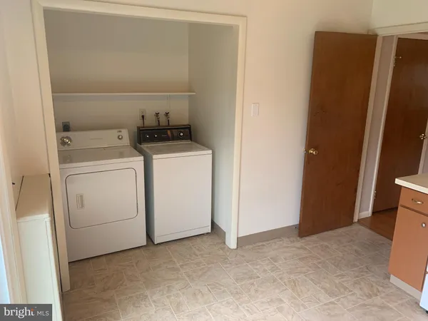 a view of storage and utility room with washer and dryer