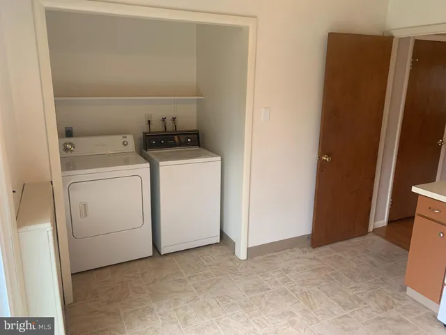 a view of storage and utility room with washer and dryer