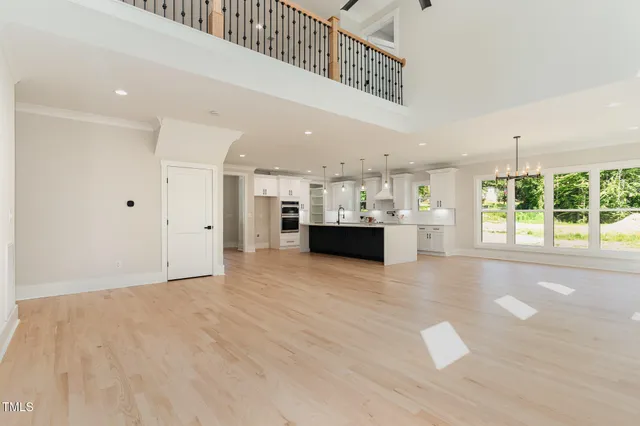 a kitchen with kitchen island a sink stainless steel appliances and a chandelier