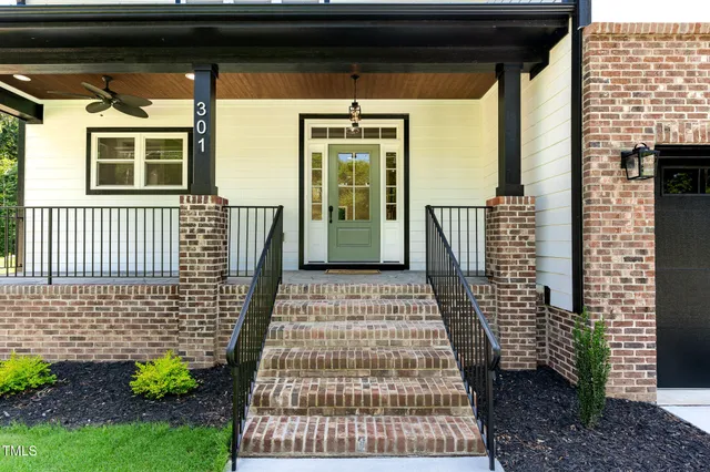a front view of a house with a yard garage and outdoor seating